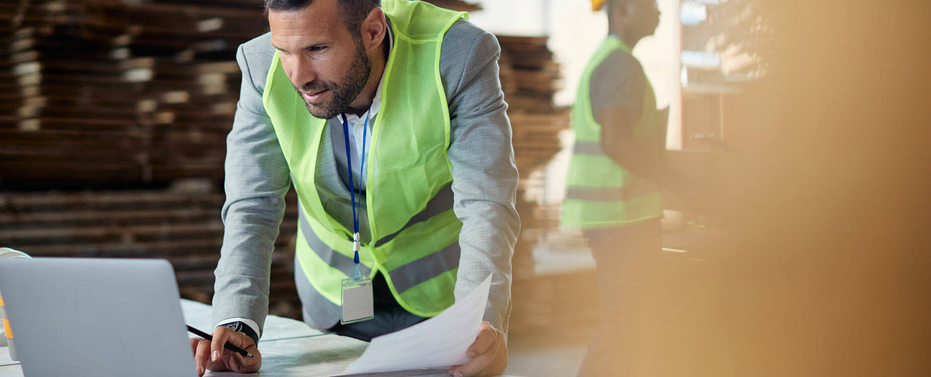 Man looking at a computer on an industrial site